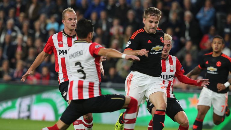 Luke Shaw of Manchester United about to be tackled by Hector Moreno of PSV Eindhoven