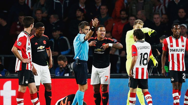 Luke Shaw of Manchester United lies on the ground injured as referee Nicola Rizzoli calls for medical assistance. 