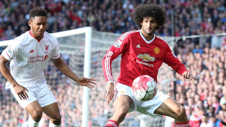 Marouane Fellaini of Manchester United attempts to hold off Liverpool's Joe Gomez 