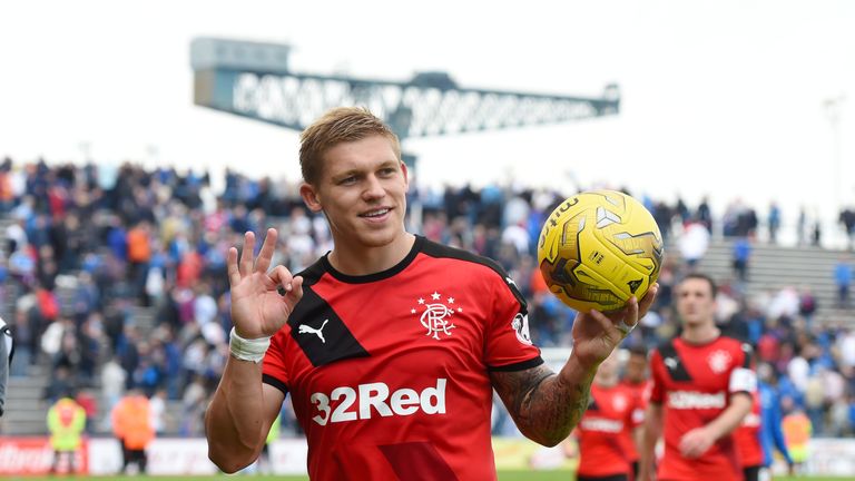 Martyn Waghorn leaves the field with the match ball after scoring a hat-trick for Rangers against Morton