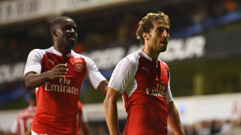 Mathieu Flamini of Arsenal (R) celebrates with Joel Campbell