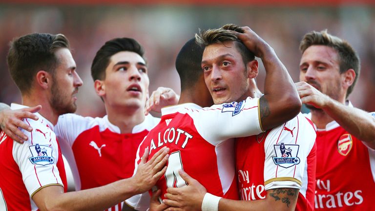Theo Walcott of Arsenal celebrates scoring the opening goal with Mesut Ozil 
