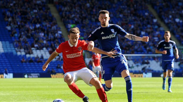 Mikhail Kennedy of Charlton Athletic is tackled by Scott Malone of Cardiff City during the Sky Bet Championship match