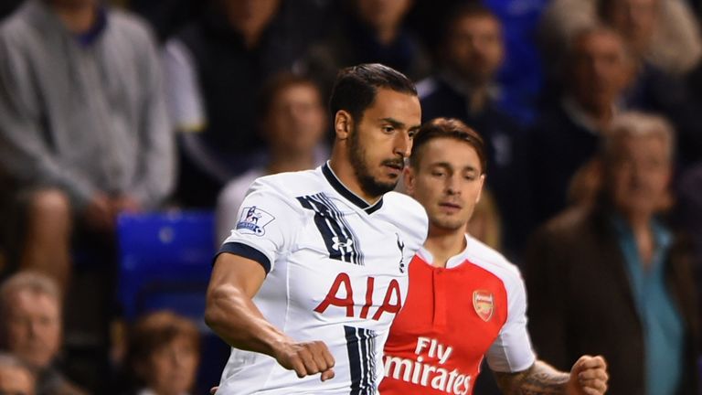 Nacer Chadli of Tottenham Hotspur is watched by Mathieu Debuchy of Arsenal