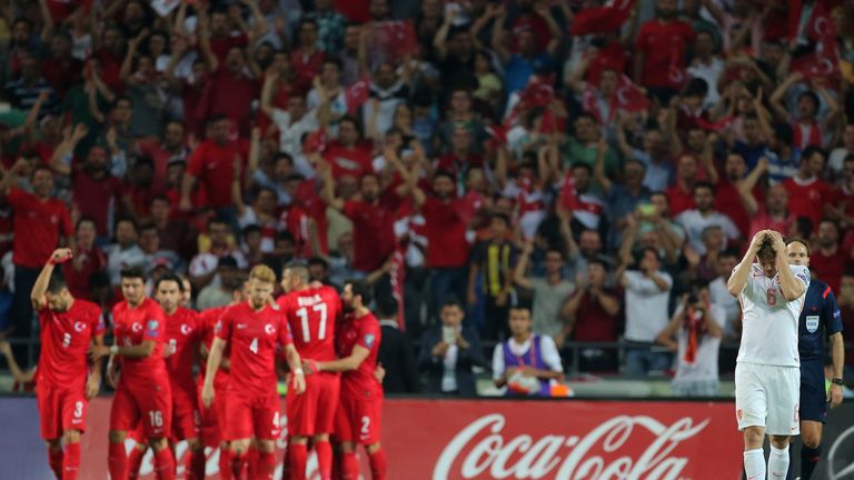 Netherlands' Daley Blind (R) gestures as Turkey's players (L) celebrate after scoring a goal during the Euro 2016 qualifying