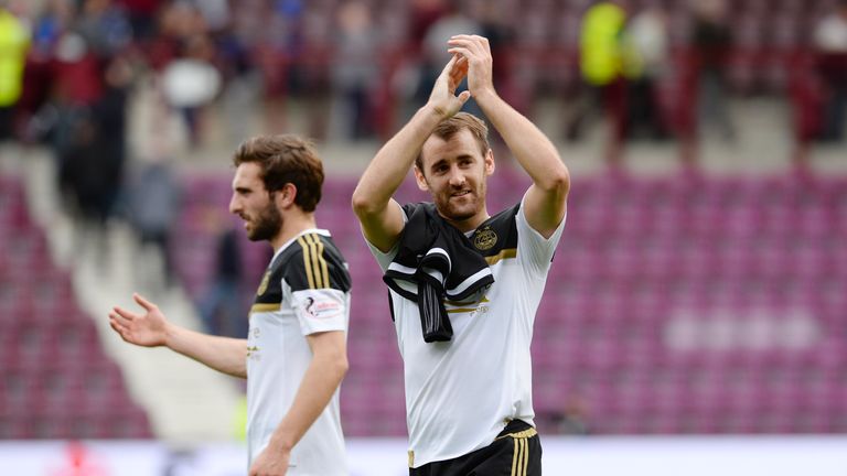 Aberdeen's Niall McGinn salutes the travelling fans after victory at Hearts