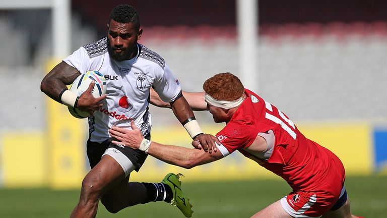 Nikola Matawalu of Fiji breaks away from Connor Braid of Canada