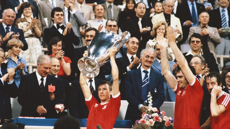 Nottingham Forest captain John McGovern lifts the trophy as Larry Lloyd (c) and Frank Clark (r) look on after the 1979 European Cup Final win over Malmo