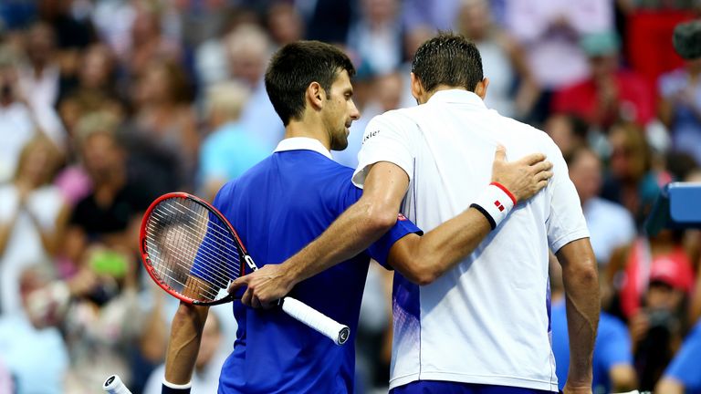 Novak Djokovic (L) embraces Marin Cilic after defeating him in the US Open semi-finals