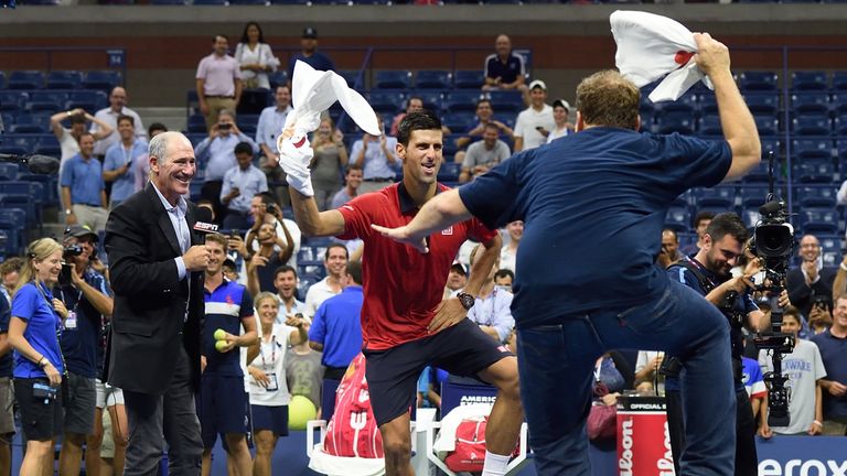 Novak Djokovic of Serbia dances with a fan on the court after defeating Andreas Haider-Maurer of Austria in their US Open 2015 second round match
