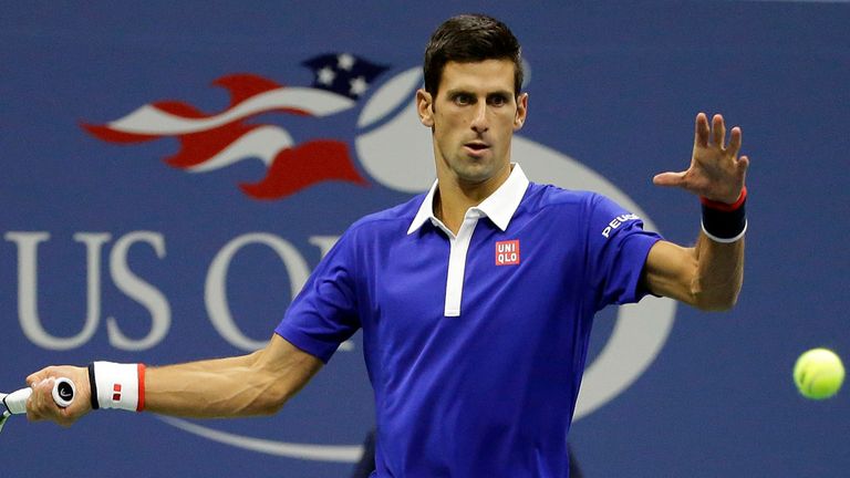 Novak Djokovic, of Serbia, returns a shot to  Roger Federer, of Switzerland