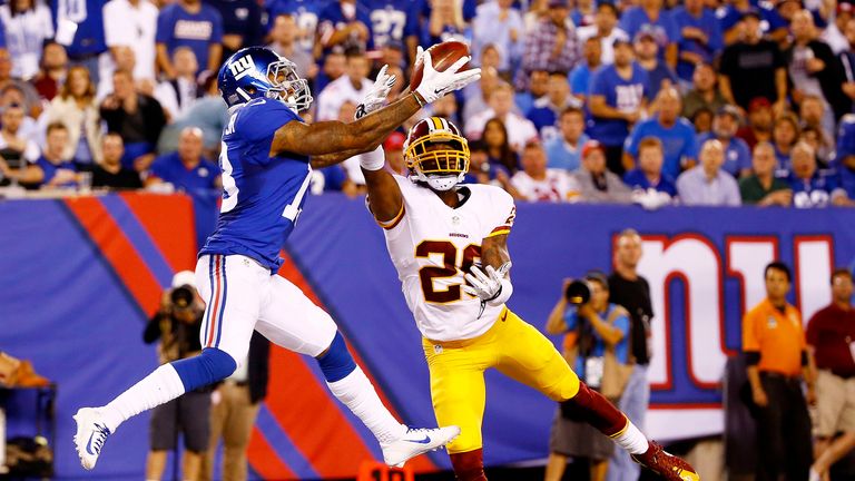 Odell Beckham of the New York Giants scores a touchdown against the defense of Bashaud Breeland of the Washington Redskins