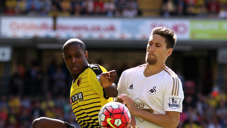 Odion Ighalo of Watford is challenged by Federico Fernandez of Swansea City