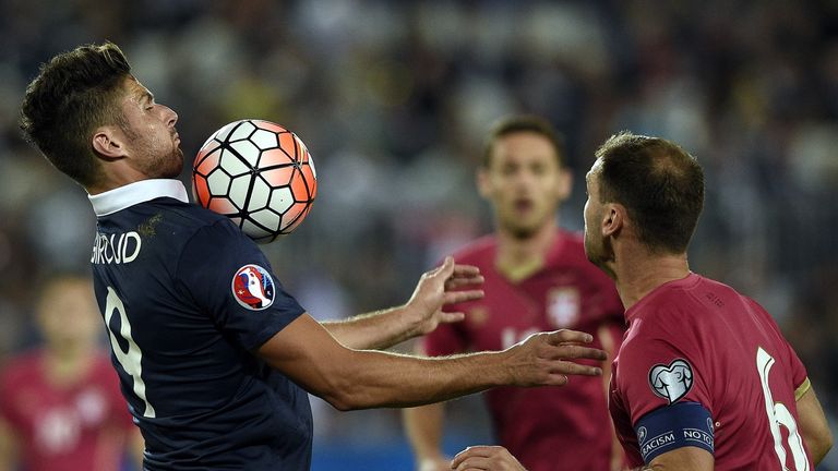 France forward Olivier Giroud (L) controls the ball next to Serbia's defender Branislav Ivanovic 