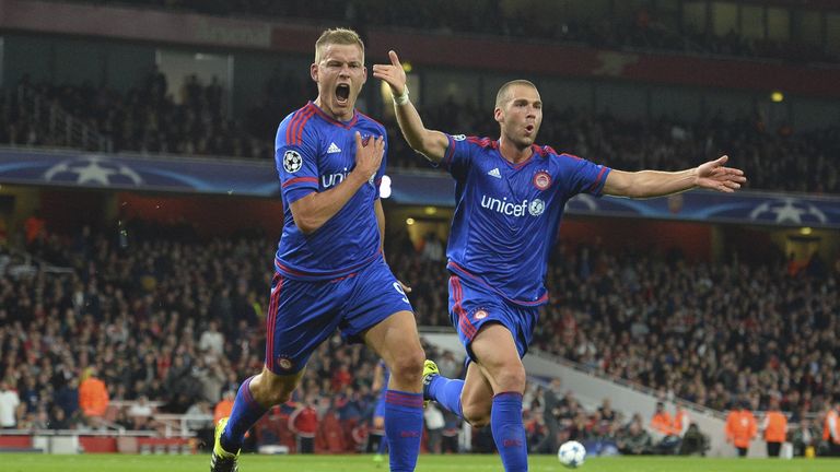 Olympiakos's Alfreo Finnbogason celebrates scoring their third goal with Pajtim Kasami.