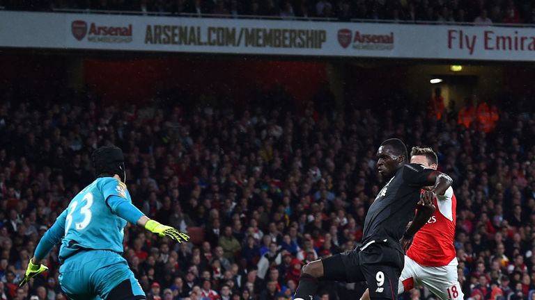 Arsenal's Petr Cech (L) saves a shot by Liverpool's Christian Benteke during the Premier League match between Arsenal and Liverpool at the Emirates stadium
