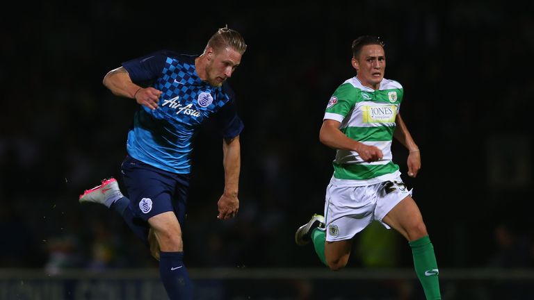 Sebastion Polter (L) of Queens Park Rangers is tracked by Connor Roberts of Yeovil