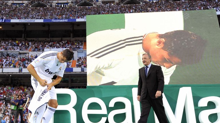 Real Madrid's new player Portuguese Cristiano Ronaldo (L) signs his new number 9 jersey next to Real Madrid president Florentino Perez (R) during his offic