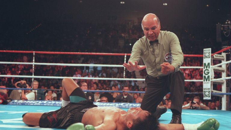 16 Mar 1996:  Ala Villamor of the Philippines is counted out by referee Mills Lane after being knocked out by Ricardo Lopez of Mexico during their WBC stra
