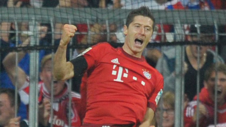 Robert Lewandowski (L) of FC Bayern Muenchen celebrates his third goal against Wolfsburg