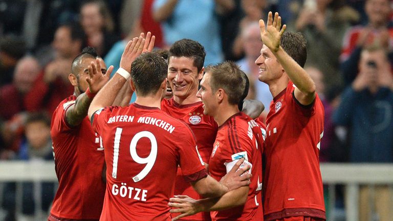 Teammates celebrate with Bayern Munich's Polish striker Robert Lewandowski (C) after his fifth goal