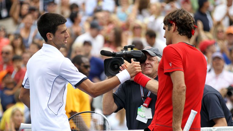 Roger Federer (R) of Switzerland congratulates Novak Djokovic of Serbia after Djokovic won their match at the US Open, 2011