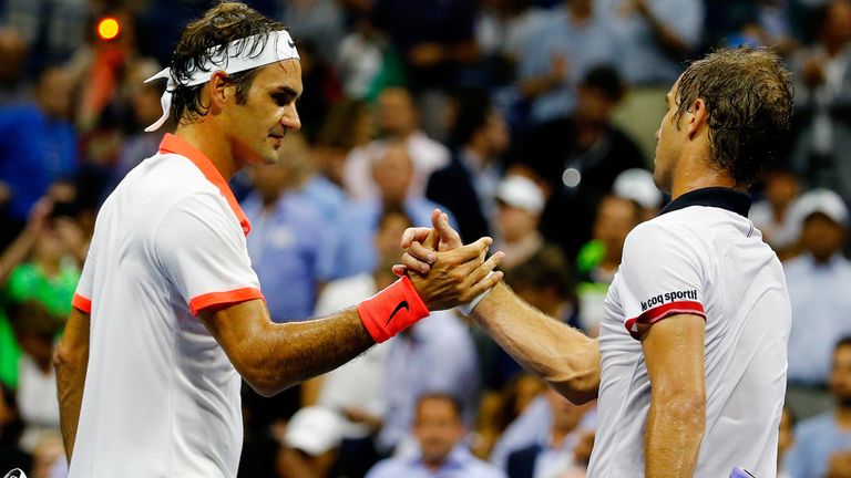 Roger Federer shakes hands with Richard Gasquet who could only win seven games in their quarter-final in the Big Apple