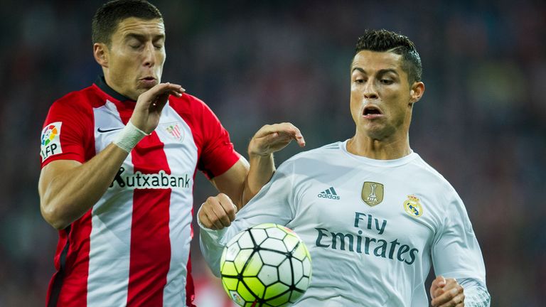 BILBAO, SPAIN - SEPTEMBER 23: Cristiano Ronaldo (R) of Real Madrid CF duels for the ball with Oscar De Marcos of Athletic Club Bilbao during the La Liga ma