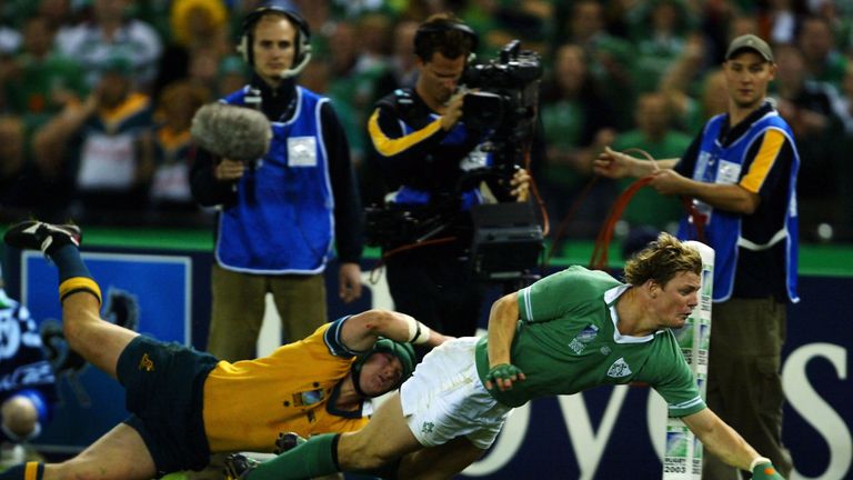 Brian O'Driscoll scores a try as he is tackled by Elton Flatley of Australia during the 2003  Rugby World Cup
