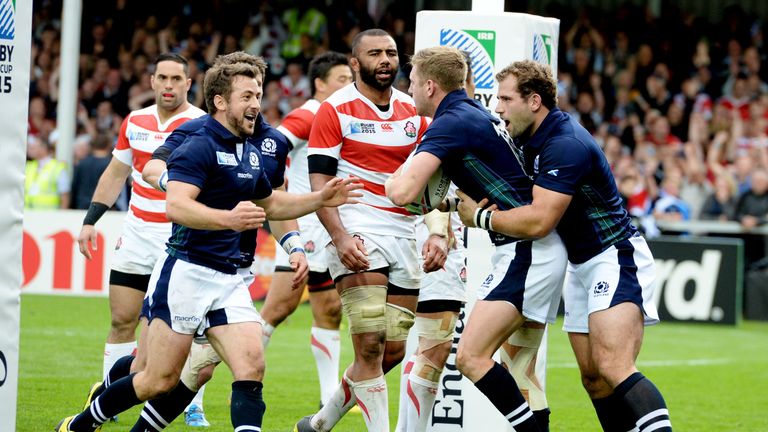 Finn Russell (middle) is congratulated after scoring Scotland's fifth try
