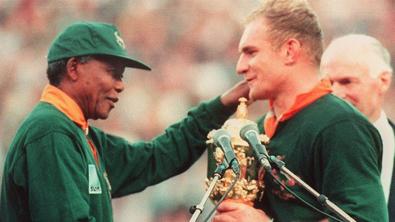 One of the most iconic moments in sport as Nelson Mandela presents the Webb Ellis Cup to South Africa captain Francois Pienaar