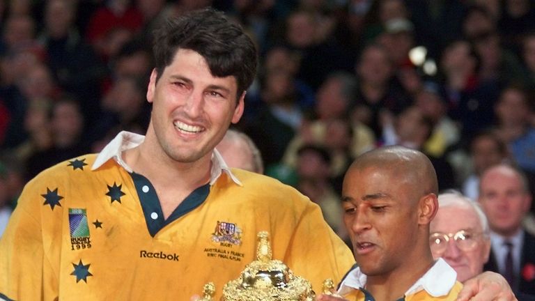 Australian captain John Eales and scrum-half George Gregan pose with the Webb Ellis Cup after their World Cup final win over France in 1999