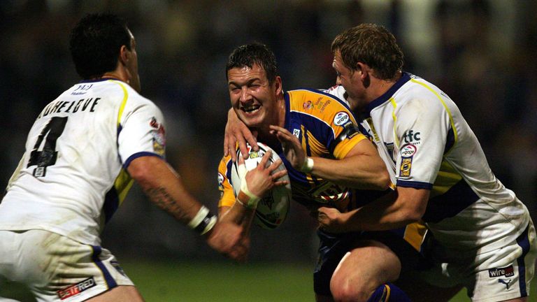 Leeds' Danny McGuire is tackled by Warrington's Toa Kohe-Love (left) and Ben Westwood during the 2006 play-offs