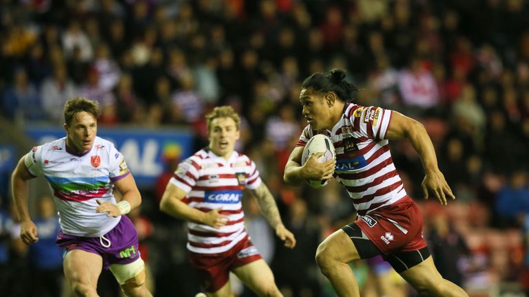 Wigan Warriors' Taulima Tautai runs through to score his try against Hull KR