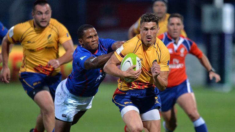 Romania's Mihai Macovei (R) beats Namibia's Tjiuee Uanivi (L) during the 2015 IRB Nations Cup 