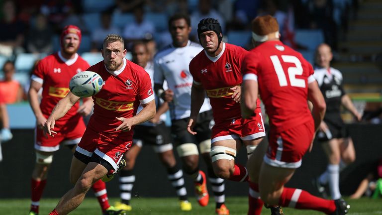 Phil Mackenzie (left) Canada passes the ball during their World Cup warm-up against Fiji