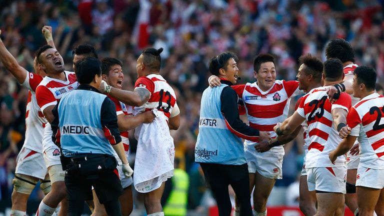 Japan players celebrate their surprise victory during the 2015 Rugby World Cup Pool B match between South Africa and Japan