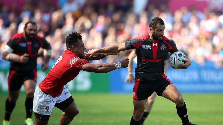 GLOUCESTER, ENGLAND - SEPTEMBER 19:  Lasha Malaguradze of Georgia hands off the tackle of Sonatane Takulua of Tonga during the 2015 Rugby World Cup Pool C 