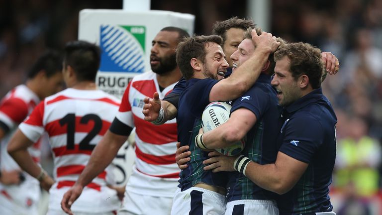 Finn Russell of Scotland is congratulated by team mates after scoring his teams fifth try