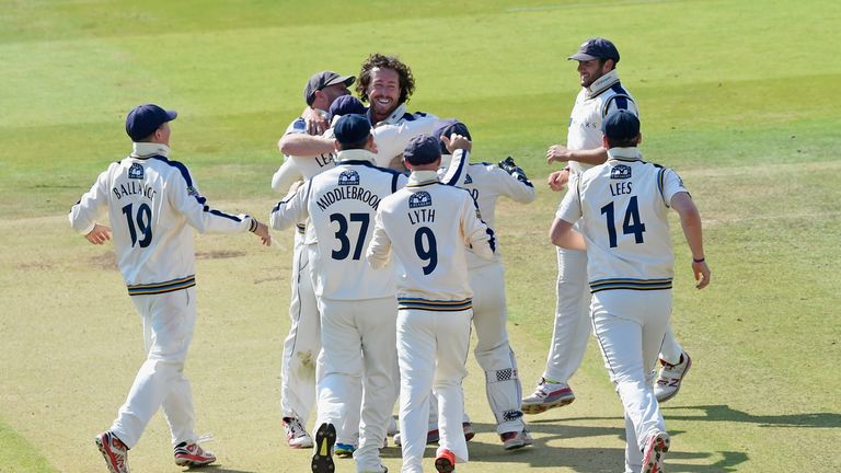 Ryan Sidebottom is mobbed by his Yorkshire team-mates after dismissing Tim Murtagh to skittle Middlesex for 106