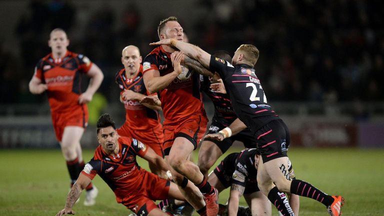Salford Red Devils' Josh Griffin is tackled by Widnes Vikings Grant Gore 