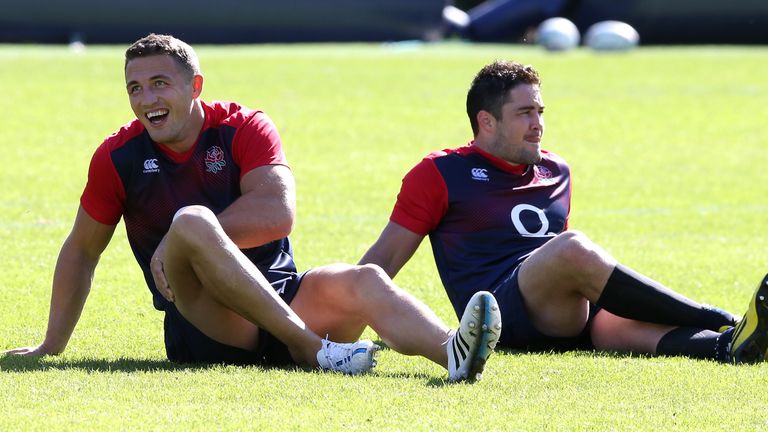 Sam Burgess (L) takes a break with team mate Brad Barritt after the England training session at Pennyhill Park on Septemb