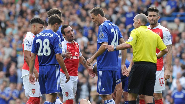 Arsenal's Santi Cazorla complains to referee Mike Dean after his 2nd yellow card during the Barclays Premier League match between Chelsea and Arsenal