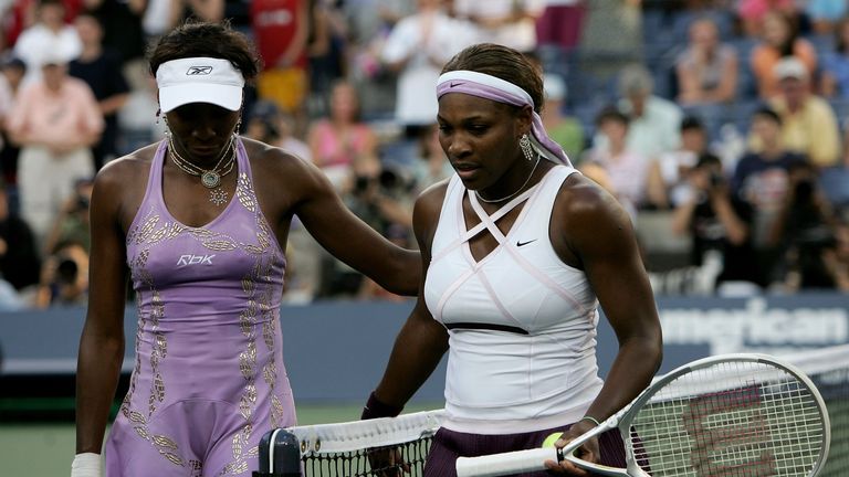 Serena Williams (R) and   Venus Williams walk on the court after their match during the US Open at the USTA National Tennis Cente