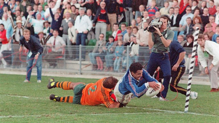 French fullback Serge Blanco dives in to score the winning try of the 1987 World Cup semi-final as Australian hooker Thomas Lawton tackles him in vain