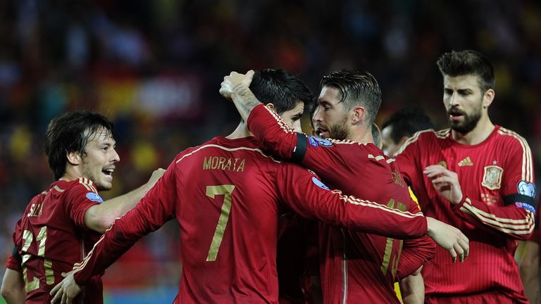 Alvaro Morata (2L) celebrates after scoring a goal with David Silva (L), Spain's defender Gerard Pique (R) and Spain's defender Sergio Ramos (2R), 