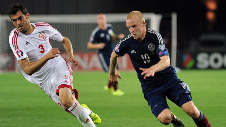 Steven Naismith (R) of Scotland  vies for a ball with Solomon Kverkvelia (L) of Georgia 