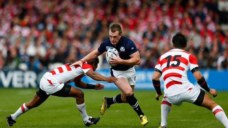 GLOUCESTER, ENGLAND - SEPTEMBER 23:  Stuart Hogg of Scotland takes on the Japan defence during the 2015 Rugby World Cup Pool B match between Scotland and J