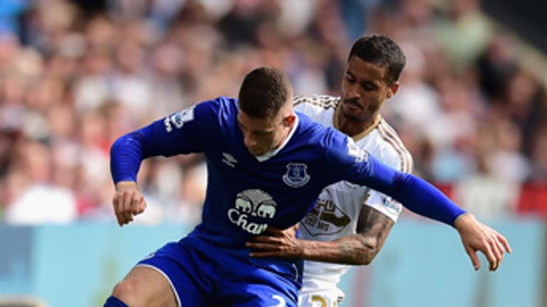 SWANSEA, WALES - SEPTEMBER 19: Ross Barkley of Everton and Kyle Naughton of Swansea City compete for the ball during the Barclays Premier League match betw