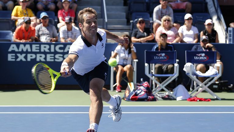 Richard Gasquet of France returns a shot to Bernard Tomic of Australia during the 2015 US Open